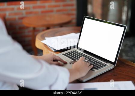 Woman with blank white screen laptop, Mockup image blank white desktop screen. Stock Photo