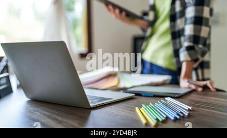 Creative designer using digital tablet creating artwork at modern workplace. Stock Photo