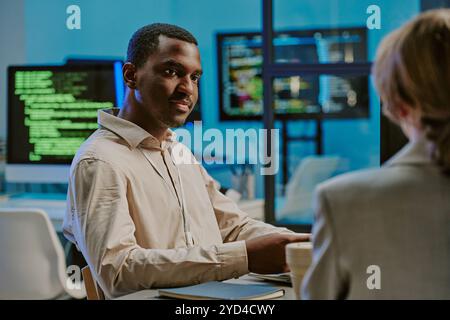 Young Black Man During Meeting In IT Office Stock Photo