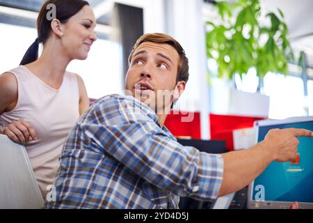 Business, people or man with pointing to computer in office for system update, internet glitch or software problem. Web developer, team or person with Stock Photo