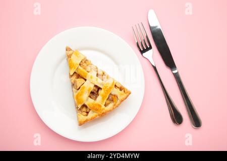 Homemade organic apple pie dessert ready to eat on pink background. Top view Stock Photo