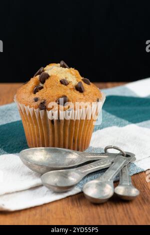 Chocolate chip muffin and measuring spoons Stock Photo