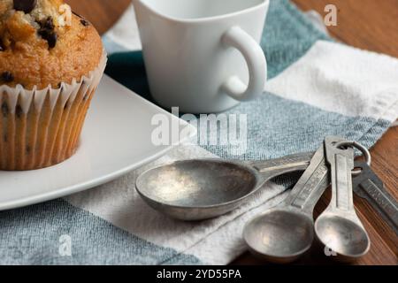 Measuring spoons, cup and muffin Stock Photo
