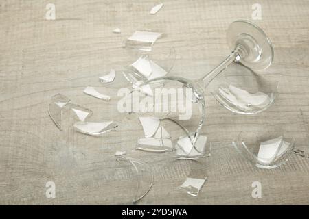 Broken wine glass on grey background. Top view Stock Photo
