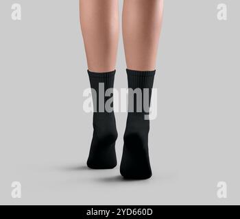 Template of black long socks on women's legs on tiptoes, back view, for pattern, isolated on background. Mockup of a pair of gaiters with high elastic Stock Photo