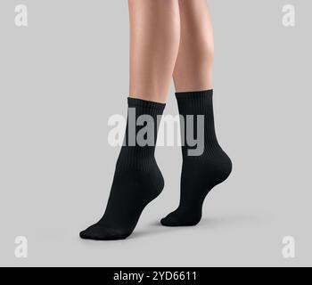 Template of black long gaiters on women's legs on tiptoes, for design, branding, advertising, side view. Mockup of a pair of socks with high elastic b Stock Photo