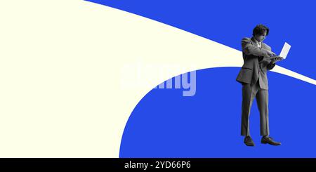 Businessman dressed in suit working on laptop, standing against minimalist blue and white abstract background. Stock Photo