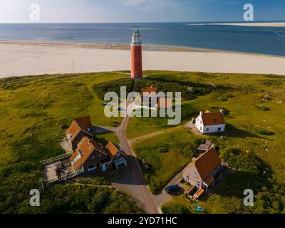 An awe-inspiring aerial view of a majestic lighthouse standing tall amidst the sandy shores of Texel, Netherlands Stock Photo