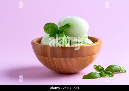 Basil ice cream in a wooden bowl. Stock Photo