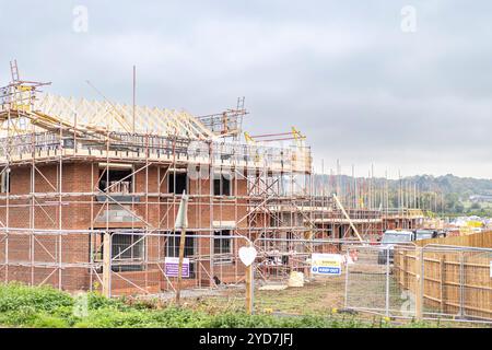 Newbuild house on a construction site with scaffolding, UK. Stock Photo