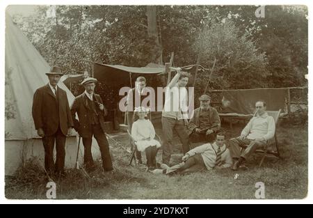 Post WW1 era postcard of young and old men camping, young brother and sister, U.K. circa 1918 PC stampbox half pence Stock Photo