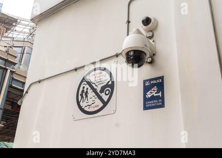 Dash camera, security camera on the building wall, financial district Singapore. "No idling engine" poster prohibiting, National Environment agency Stock Photo