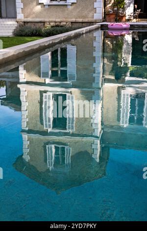 Luxury villa in South of France reflected on water surface of pool. Stock Photo