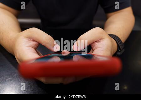 Man playing game on mobile phone. gamer boy playing video games holding SmartphoneÂ working mobile devices. cell telephone techn Stock Photo