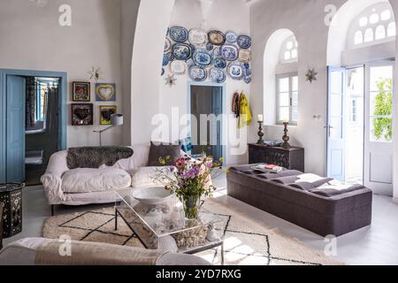 Wall mounted ceramic plates and seating area in historic house on the Island of Tinos in Greece Stock Photo