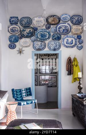 Collection of wall mounted ceramic plates displayed above doorway inside historic house on the Island of Tinos in Greece Stock Photo