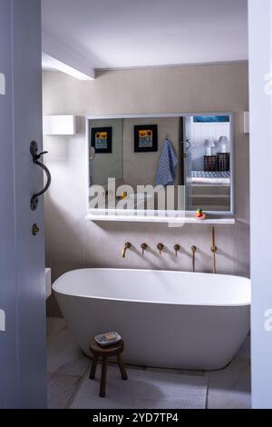 Freestanding bath with wall mounted cabinet in historic house on the Island of Tinos in Greece Stock Photo