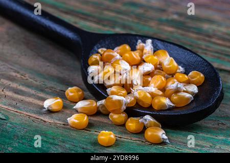 Close-up of corn kernels in a wooden spoon. Stock Photo