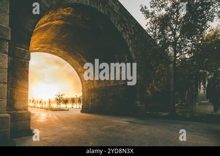 The Old bridge in Maribor at sunrise with golden light and dark shadows Stock Photo