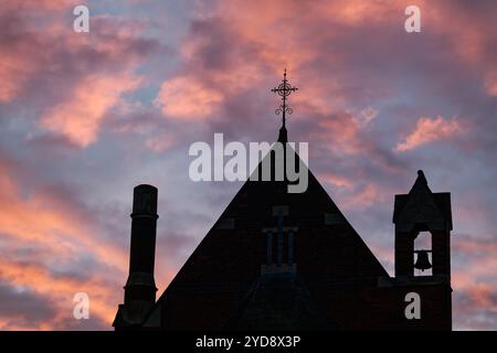 Silhouette of All Souls church against sunset orange tinged clouds, St Margarets, London, England Stock Photo