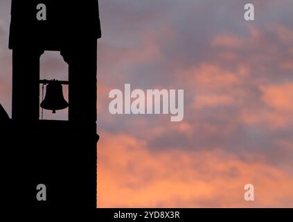 Silhouette of All Souls church against sunset orange tinged clouds, St Margarets, London, England Stock Photo