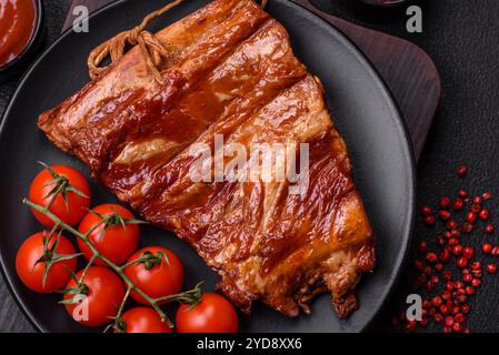 Delicious smoked or grilled ribs with olives, spices and herbs Stock Photo