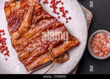 Delicious smoked or grilled ribs with olives, spices and herbs Stock Photo