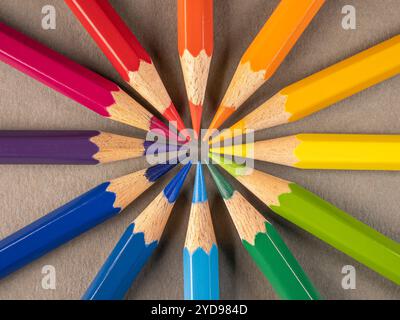A row of colored pencils arranged in a circle with the tips inward. Stock Photo