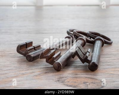 Antique iron keys on wooden background Stock Photo