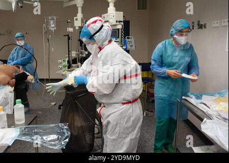 Medical professionals preparing for surgery, wearing protective gear. Medical professionals preparing for surgery. 016847 062 Stock Photo