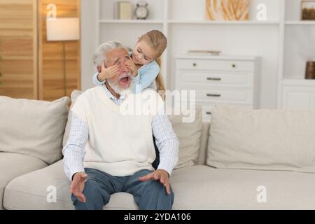Grandpa and his granddaughter having fun at home Stock Photo