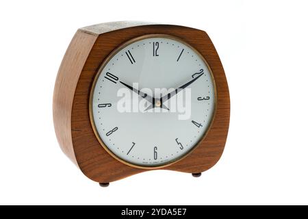 A retro wooden cased mantelpiece clock from the 1960's - white background Stock Photo
