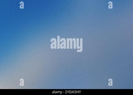 Blue grainy texture fading to white in abstract background Stock Photo