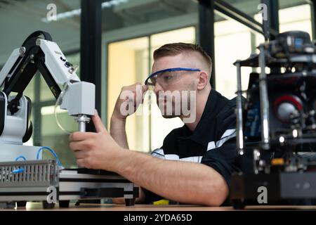 Students studying robotic hand technology are learning how to construct robotic hands for a range of industrial uses. Stock Photo
