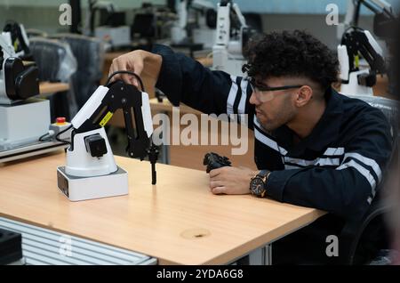 Students studying robotic hand technology are learning how to construct robotic hands for a range of industrial uses. Stock Photo