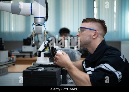 Students studying robotic hand technology are learning how to construct robotic hands for a range of industrial uses. Stock Photo