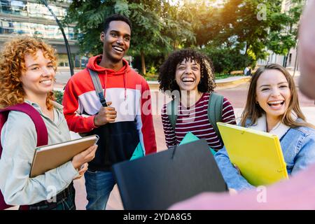 Happy young college students talking together on campus Stock Photo