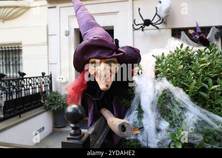 A witch on her broom with large spiders covered cobwebs outside a Carnegie Hill townhouse in New York, N.Y., Wednesday, Oct. 23, 2024. (Photo: Gordon Donovan) Stock Photo