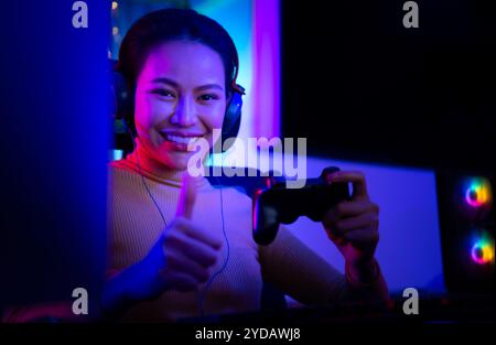 An active and serious young woman gamer on his powerful personal computer, playing first-person online video games. Stock Photo