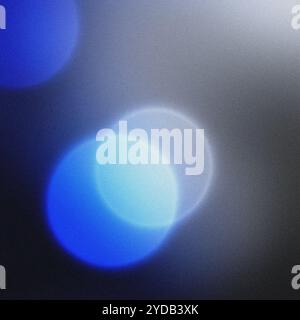 Soft and dreamy background with a nostalgic feel created by grainy blue bokeh lights Stock Photo