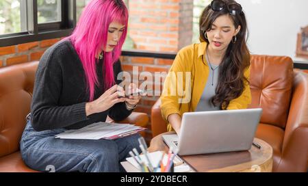 LGBTQ+ transgender man Beautiful Authentic SpecialistÂ with Pink Hair and Non-binary trans working together Working Design in cr Stock Photo