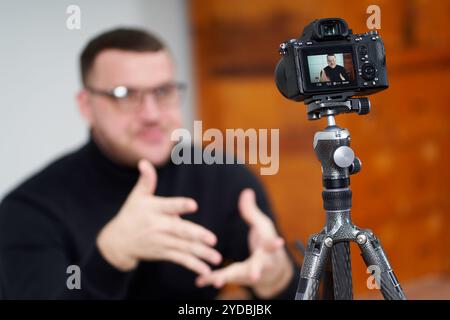 Man filming video blog on camera with tripod for online followers. In social media, Influencer, new technology and internet conc Stock Photo