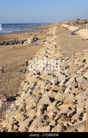 Global warming, rising sea levels and coastal retreat. Rockfilling the coastline in the seaside village of Lacanau-Océan to slow the retreat of the At Stock Photo