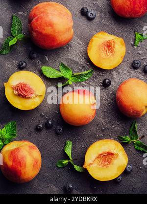 Fresh ripe peaches with blueberries top view Stock Photo