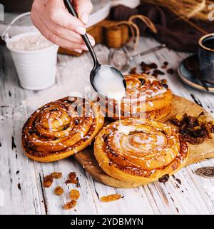 Homemade raisin roll pastry with vanilla icing Stock Photo