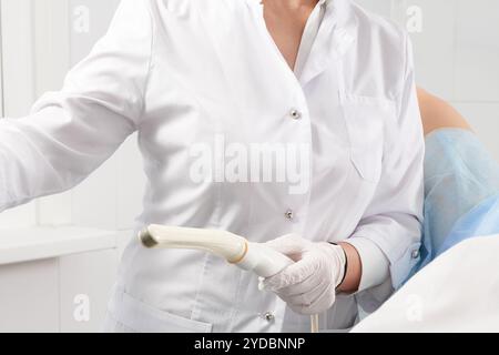 Cropped view of gynecologist holding transvaginal ultrasound wand to exam a woman Stock Photo