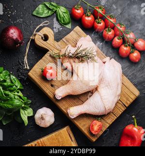 Fresh raw chicken thighs, legs on a cutting board with spices Stock Photo