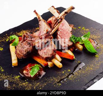 Roasted lamb rack served with carrot, yellow curry and lamb sauce Stock Photo