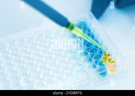 Lab Worker Adding Liquid to Test Tubes Stock Photo