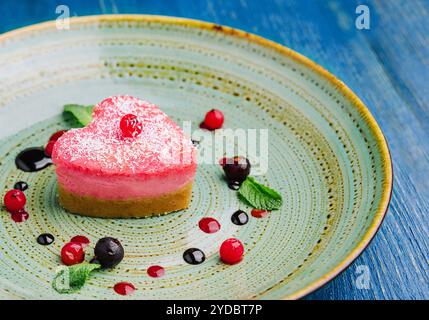 Heart shaped raw vegan red cake with raspberries Stock Photo